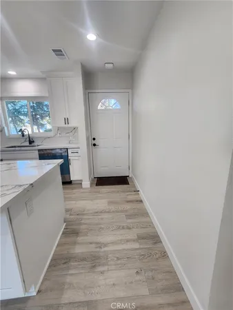 a view of a kitchen from the hallway