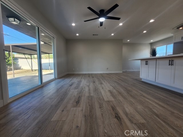 693 West Wilson Street Banning, CA 92220 - Photo 31 of 48 an empty room with wooden floor and windows