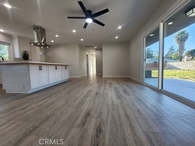693 West Wilson Street Banning, CA 92220 - Photo 32 of 48 an empty room with wooden floor and windows