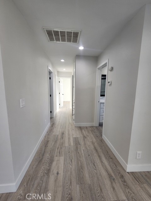 693 West Wilson Street Banning, CA 92220 - Photo 33 of 48 wooden floor in an empty room with a window