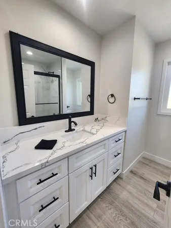 a bathroom with a double vanity sink and mirror