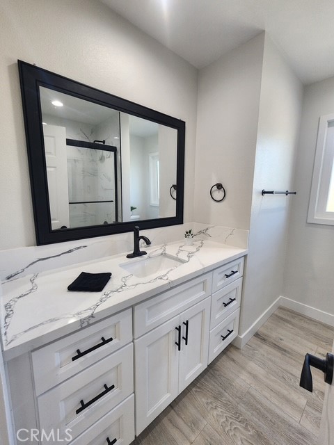 693 West Wilson Street Banning, CA 92220 - Photo 34 of 48 a bathroom with a double vanity sink and mirror