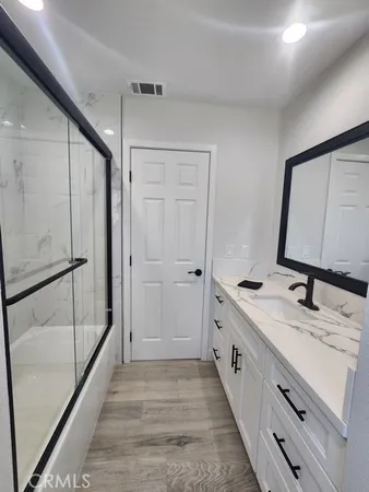 a bathroom with a double vanity sink and mirror
