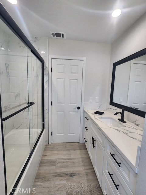 693 West Wilson Street Banning, CA 92220 - Photo 36 of 48 a bathroom with a double vanity sink and mirror