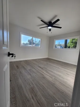 a view of a room with wooden floor