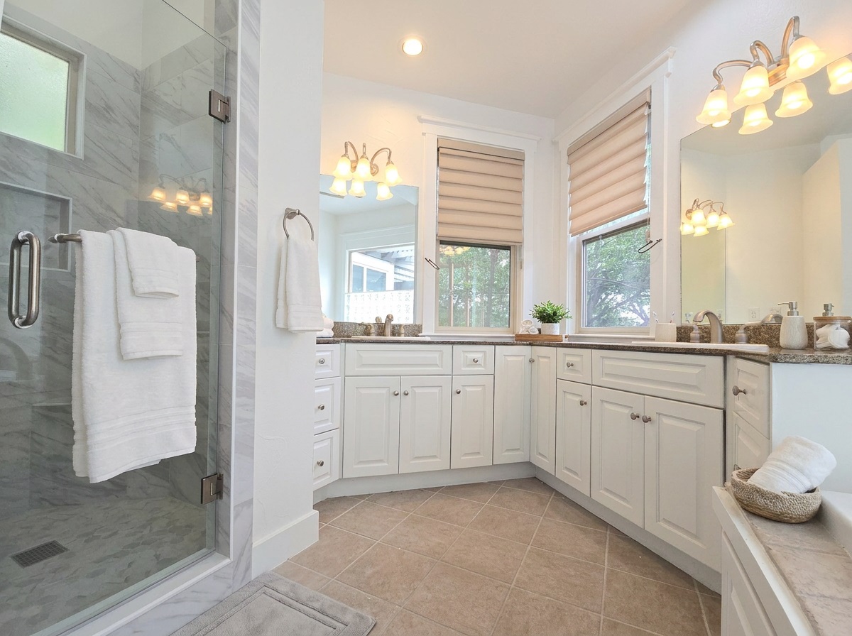 2800 Waymaker Way, Unit 24 Austin, TX 78746 - Photo 6 of 14 Glass-enclosed shower with marble-finish tile surround and transom window