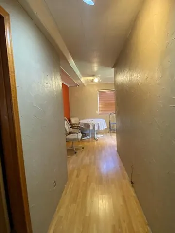 a view of a room with wooden floor