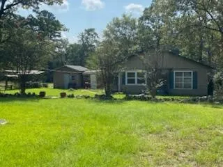 a view of house with backyard space and garden