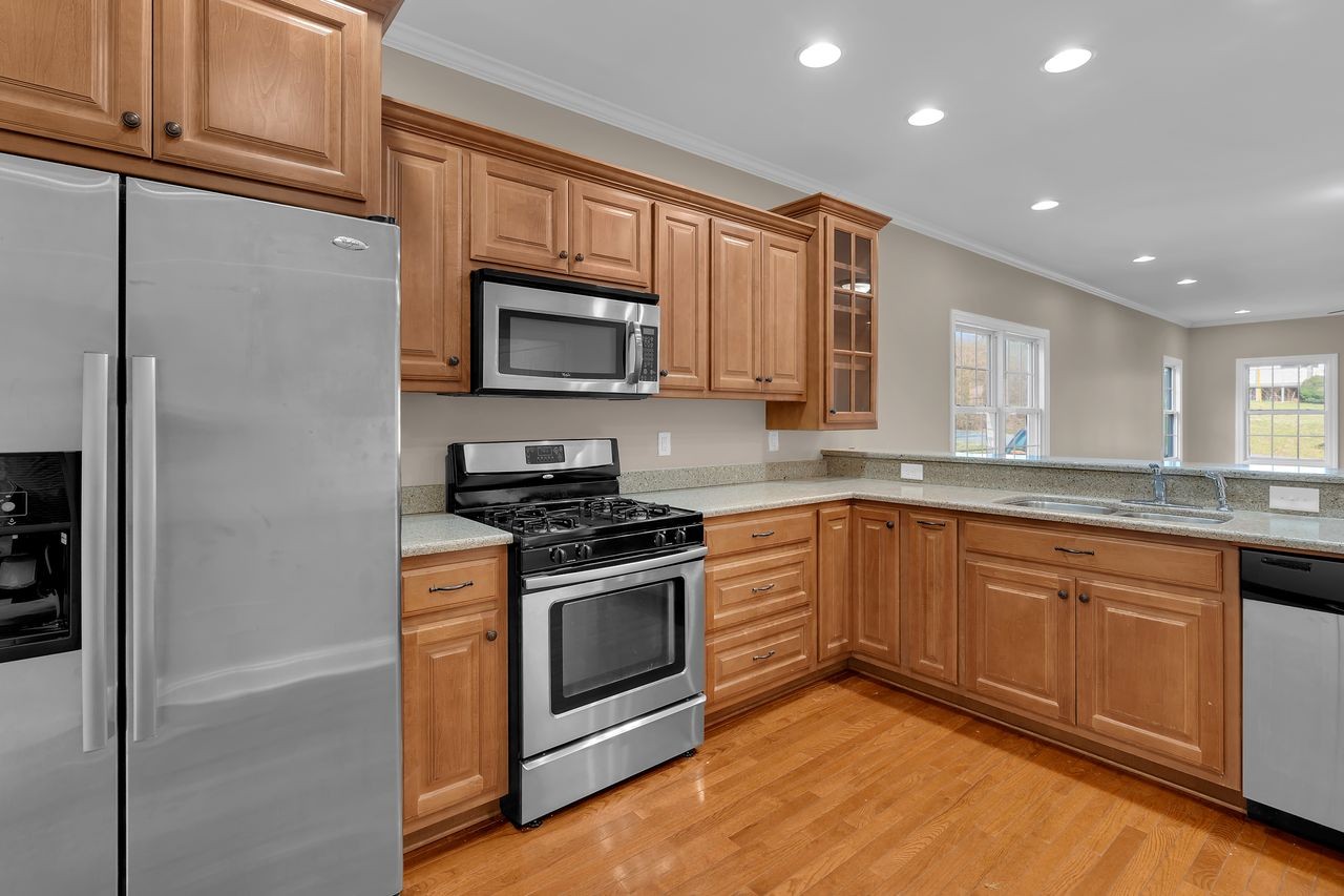 111 Reed's Lane Sewanee, TN 37375 - Photo 11 of 36 a kitchen with granite countertop cabinets stainless steel appliances and a counter space