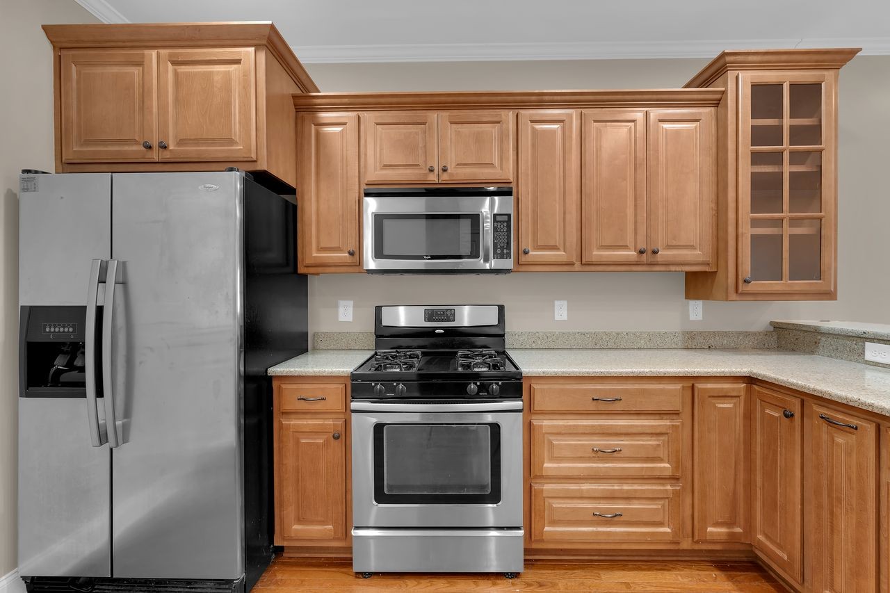 111 Reed's Lane Sewanee, TN 37375 - Photo 12 of 36 a kitchen with granite countertop a refrigerator stove and microwave