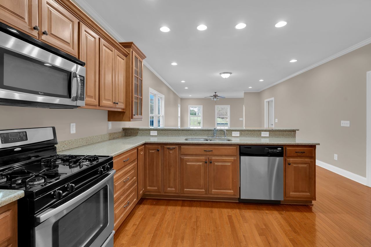 111 Reed's Lane Sewanee, TN 37375 - Photo 13 of 36 a kitchen with stainless steel appliances granite countertop a stove a sink and a microwave