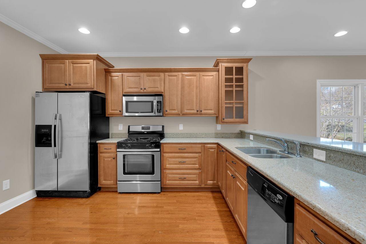 111 Reed's Lane Sewanee, TN 37375 - Photo 14 of 36 a kitchen with granite countertop a sink and stainless steel appliances