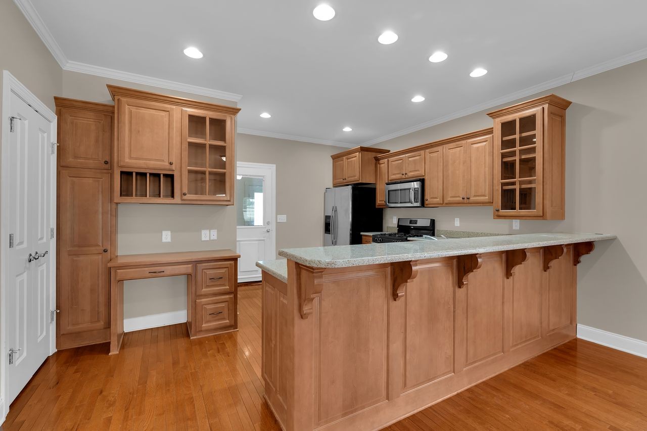 111 Reed's Lane Sewanee, TN 37375 - Photo 15 of 36 a kitchen with stainless steel appliances granite countertop a stove top oven a sink dishwasher and a microwave oven with wooden floor