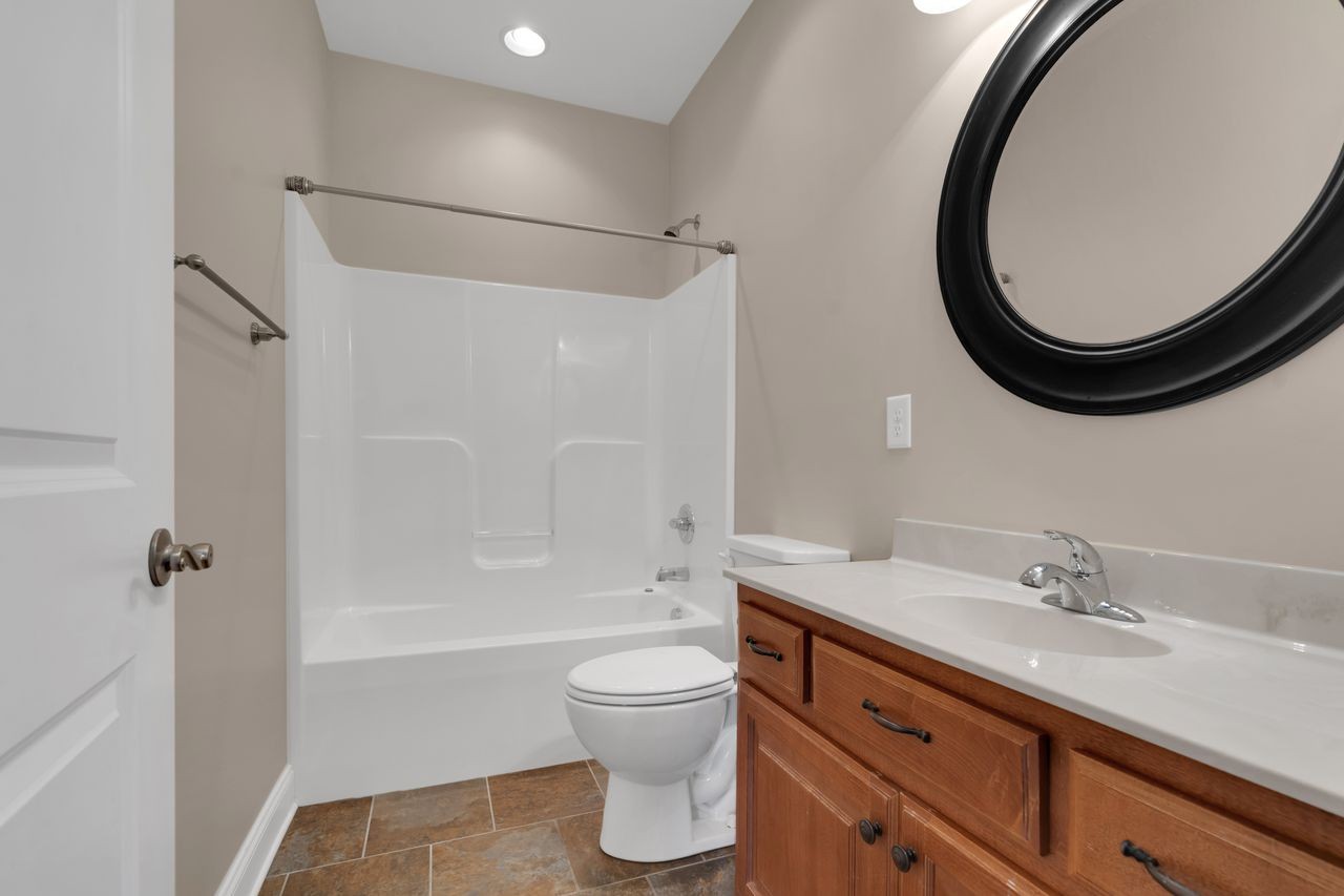 111 Reed's Lane Sewanee, TN 37375 - Photo 29 of 36 a bathroom with a granite countertop toilet a sink and a mirror