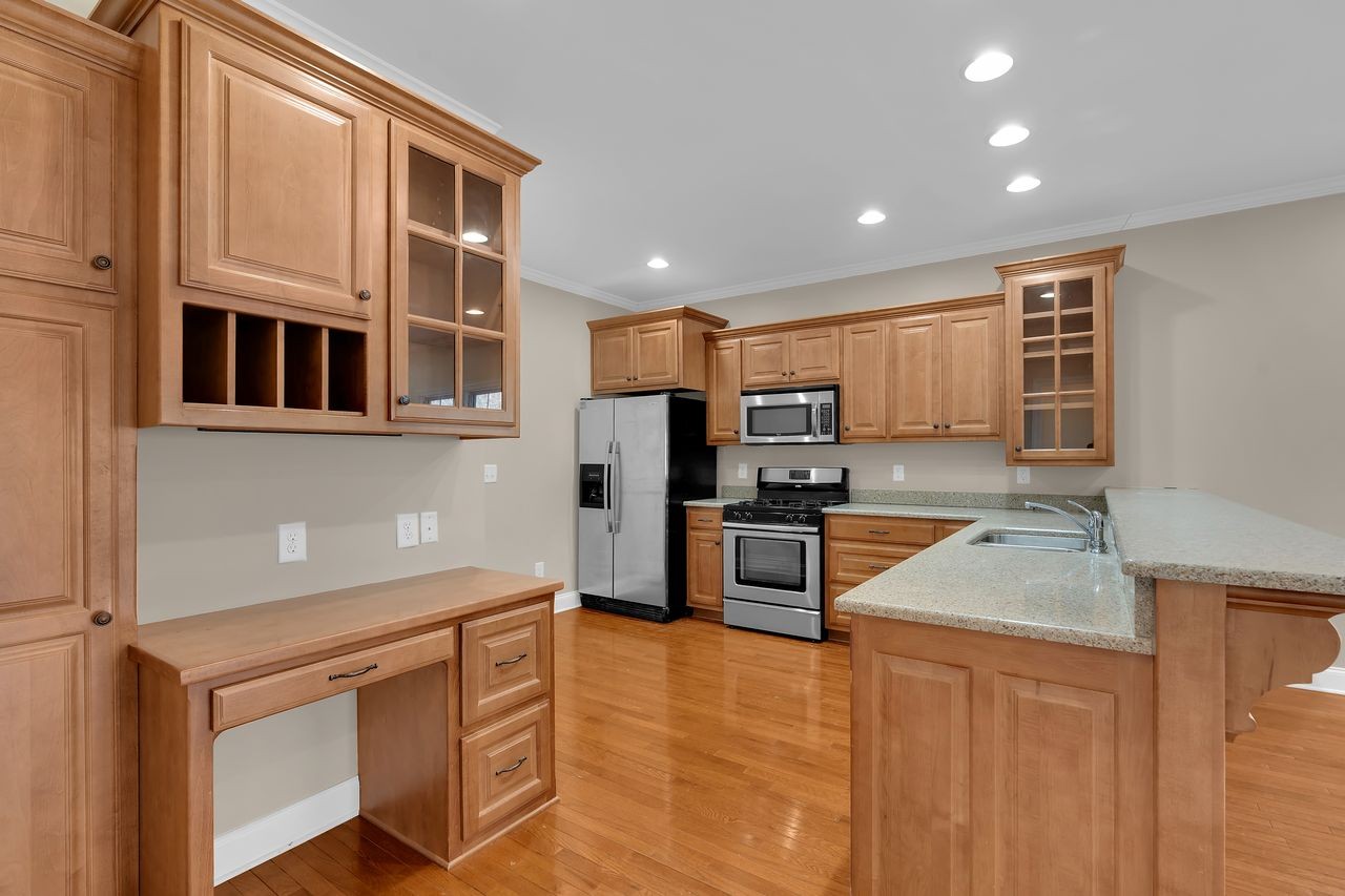 111 Reed's Lane Sewanee, TN 37375 - Photo 10 of 36 a kitchen with stainless steel appliances granite countertop a refrigerator and stove