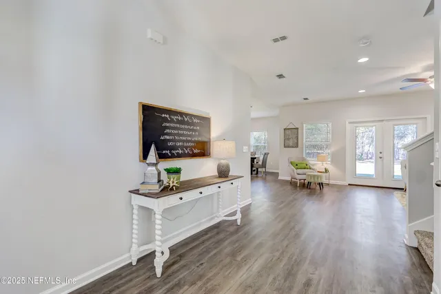 a view of a hallway with wooden floor and staircase