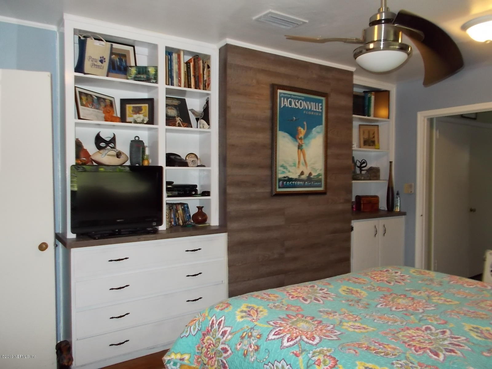 1501 River Bluff Road North Jacksonville, FL 32211 - Photo 19 of 33 a bedroom with a bed and a flat screen tv