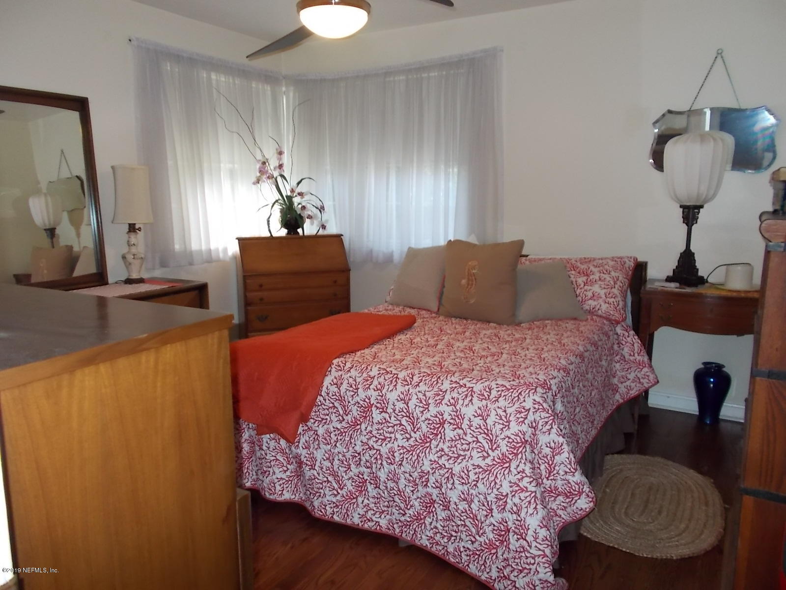 1501 River Bluff Road North Jacksonville, FL 32211 - Photo 20 of 33 a bedroom with a bed and dresser with mirror