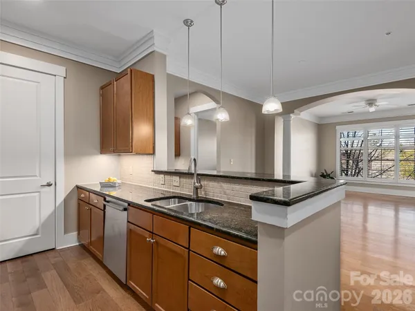a kitchen with stainless steel appliances granite countertop a sink and a stove