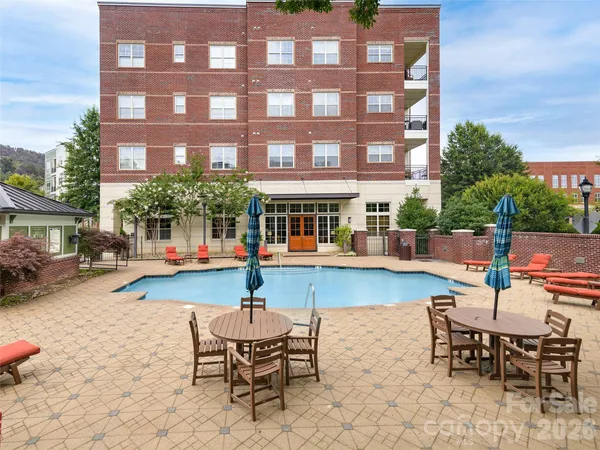 a swimming pool view with a outdoor seating