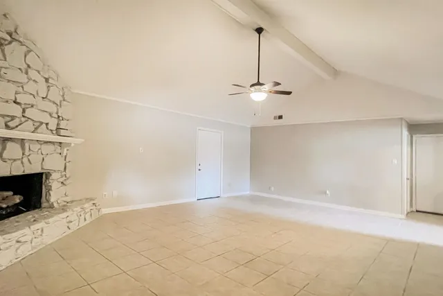 a view of empty room with fireplace