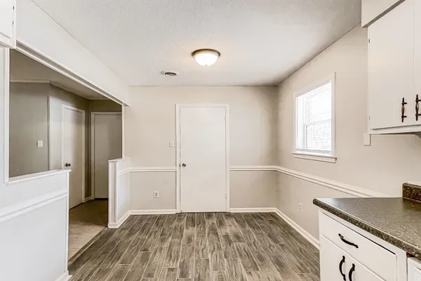 a view of a kitchen with wooden floor and a sink