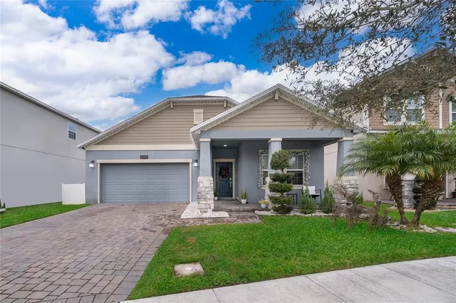 a front view of a house with a garden and plants