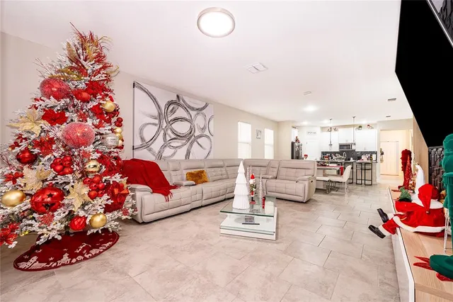 a living room with furniture and a floor to ceiling window