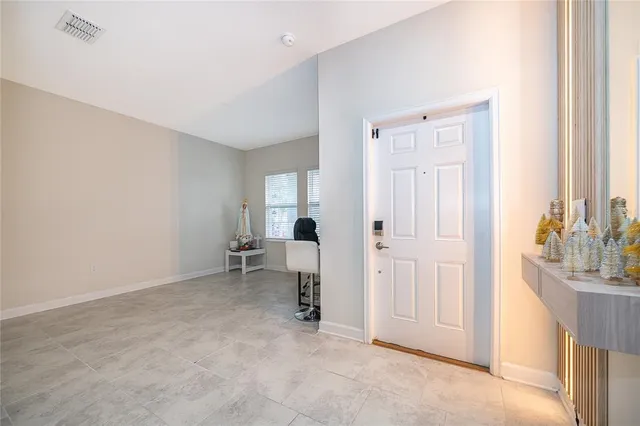 a view of a workspace with furniture and a window