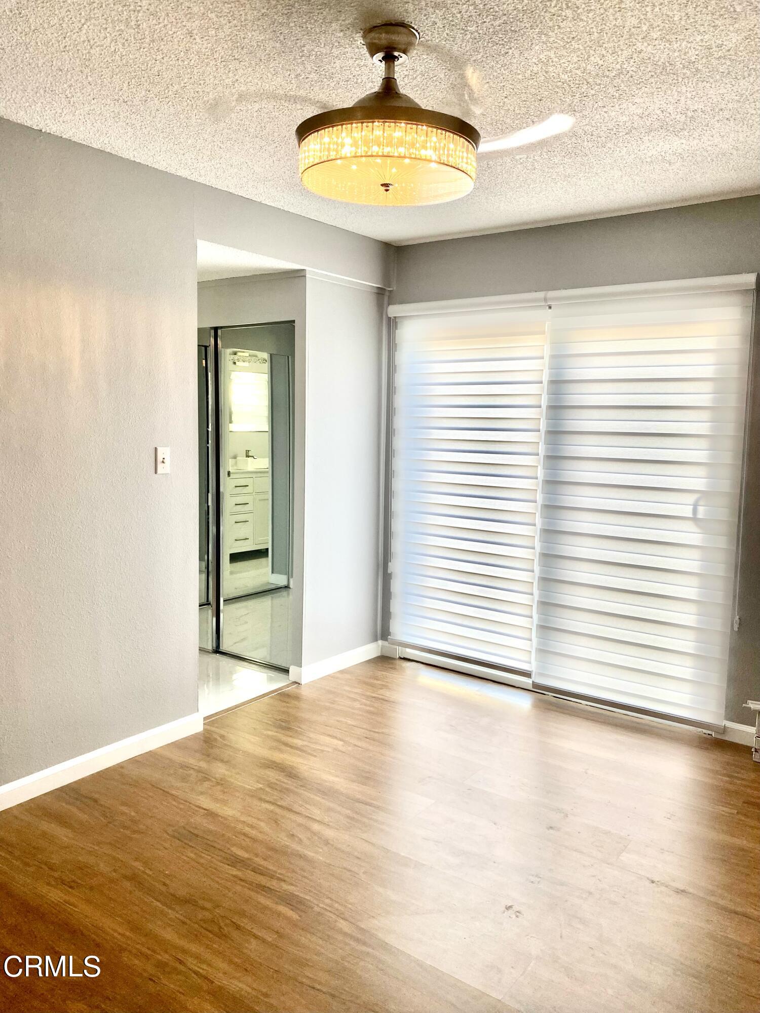 517 View Crest Drive Montebello, CA 90640 - Photo 14 of 21 a view of an empty room with a window and wooden floor