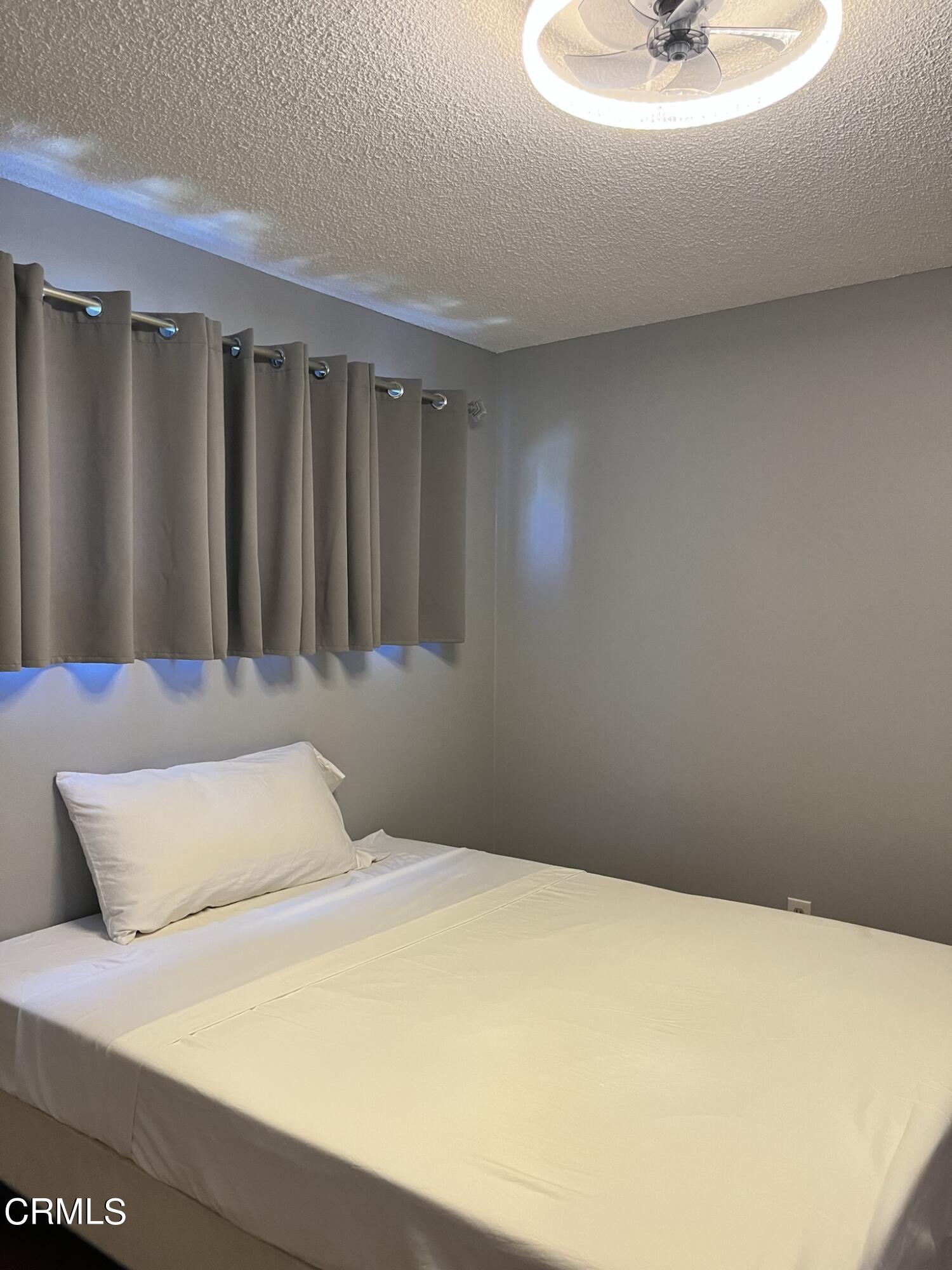 517 View Crest Drive Montebello, CA 90640 - Photo 10 of 21 a bedroom with a bed and a table