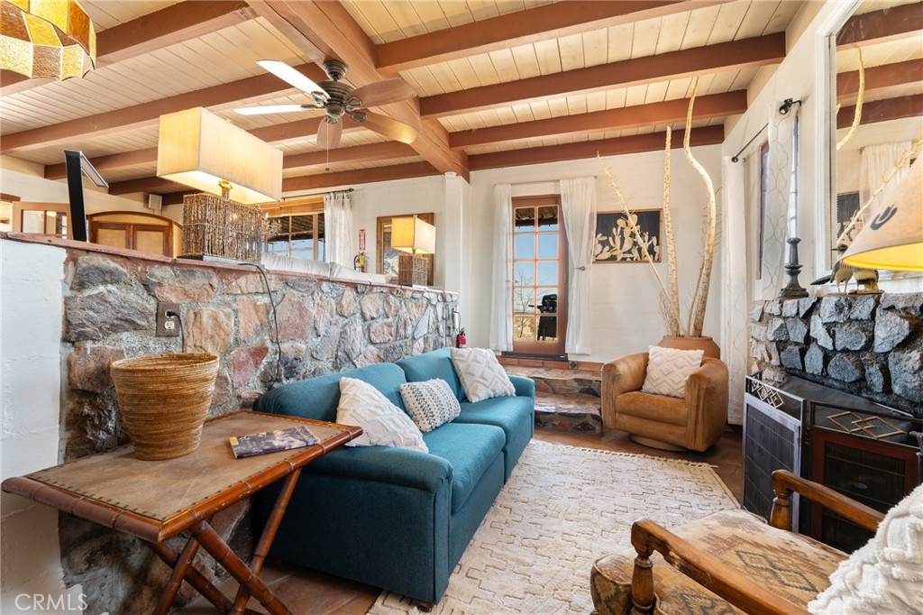 5148 Godwin Road Twentynine Palms, CA 92277 - Photo 16 of 39 a living room with furniture and a flat screen tv