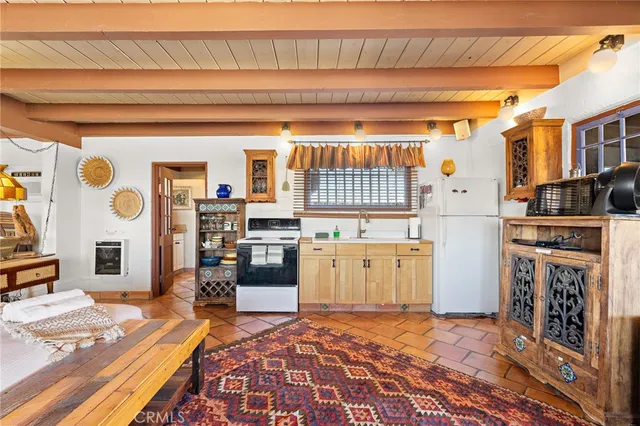 a kitchen with a refrigerator and a stove