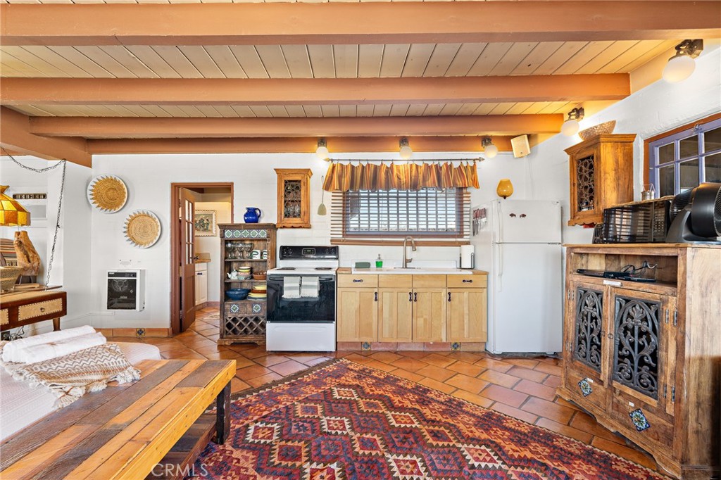5148 Godwin Road Twentynine Palms, CA 92277 - Photo 18 of 39 a kitchen with a refrigerator and a stove