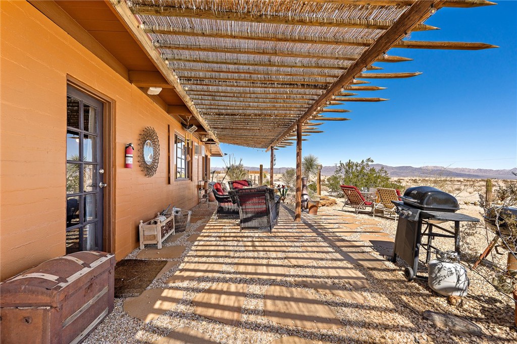 5148 Godwin Road Twentynine Palms, CA 92277 - Photo 23 of 39 a view of a porch with furniture and a patio