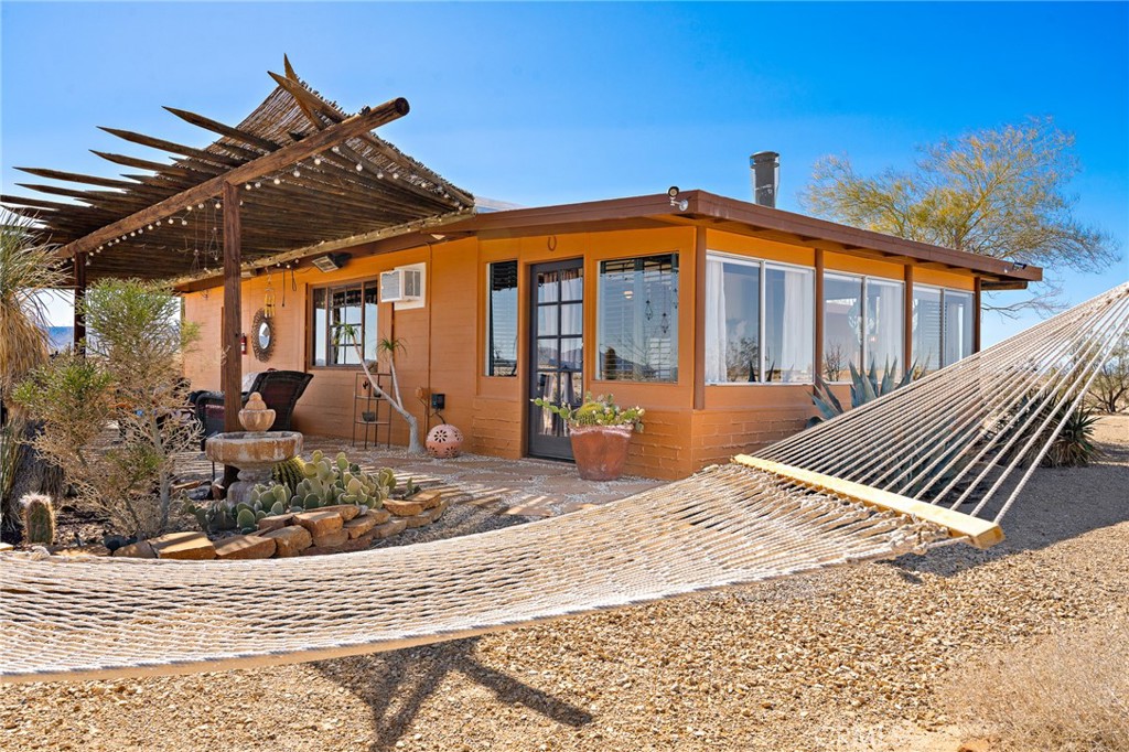 5148 Godwin Road Twentynine Palms, CA 92277 - Photo 26 of 39 a view of a house with backyard porch and sitting area