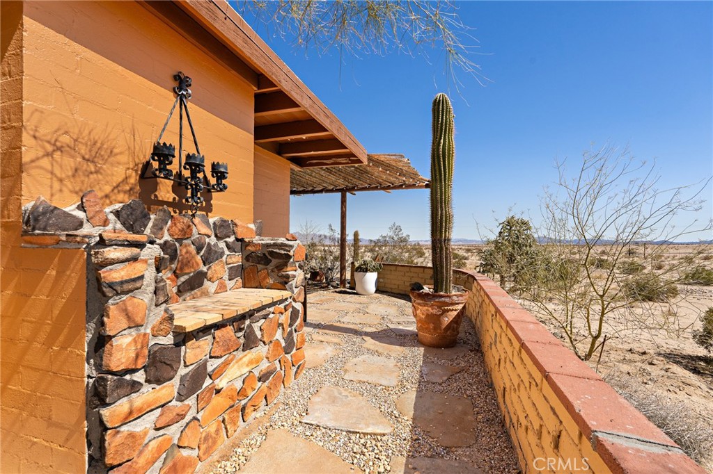 5148 Godwin Road Twentynine Palms, CA 92277 - Photo 30 of 39 a view of a balcony with chairs and iron fence
