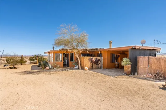 a view of a dirt road with a building in the background