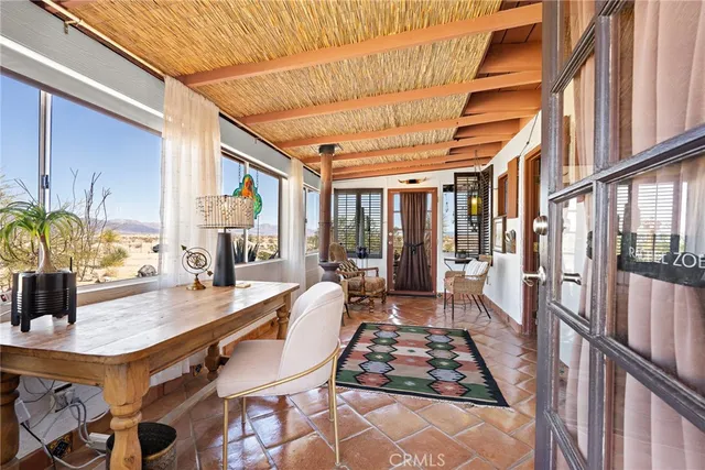 a dining room with furniture and wooden floor