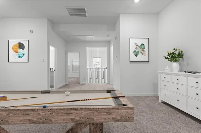 a view of a bedroom with wooden floor and cabinet