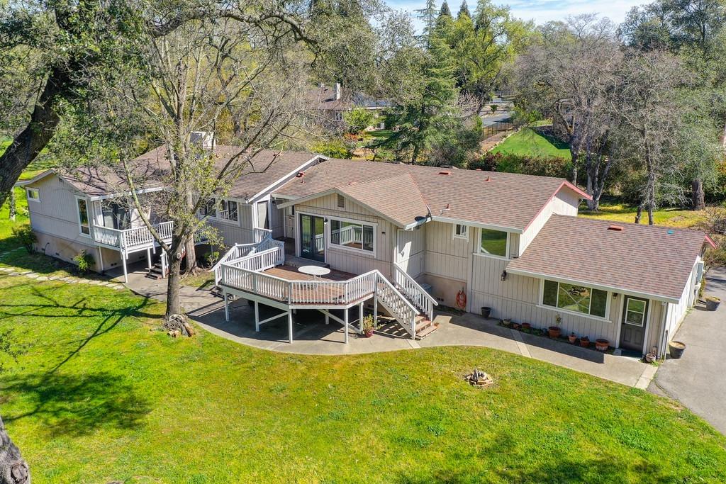 aerial view of a house with a big yard and large trees