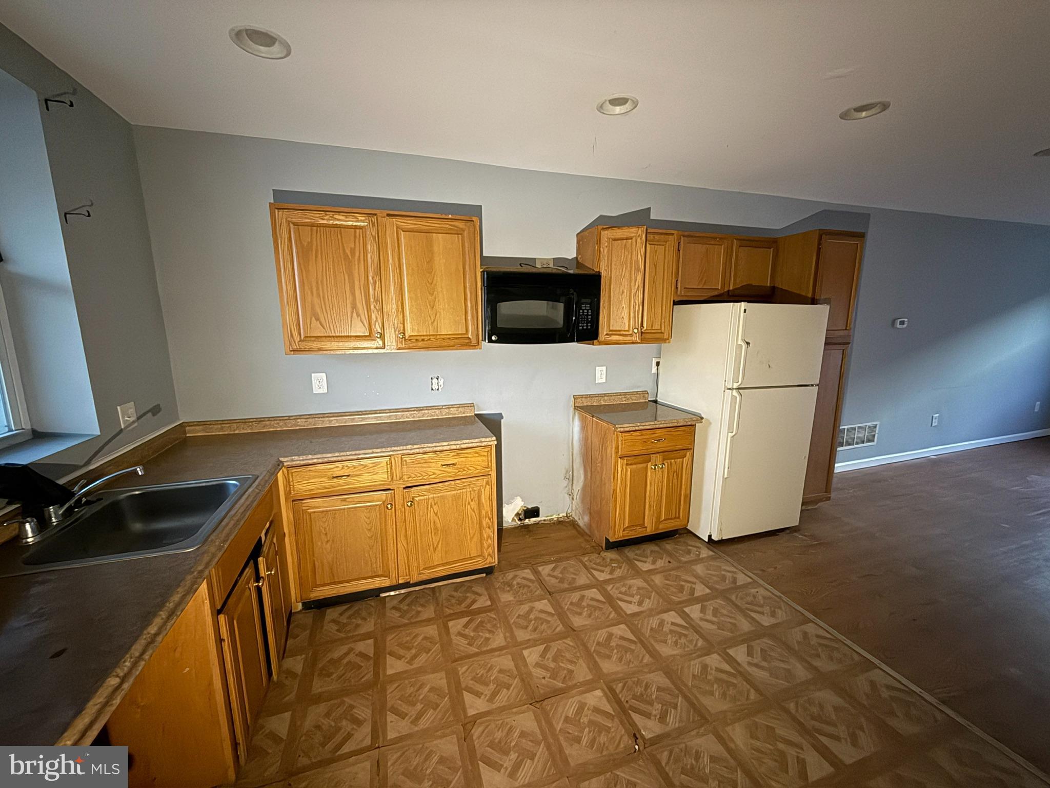 117 North Janney Street Baltimore, MD 21224 - Photo 4 of 13 a kitchen with sink a stove and a refrigerator