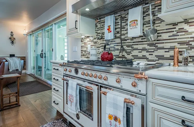 a kitchen with stove and cabinets