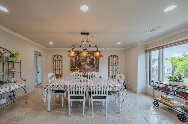 a large white kitchen with a large window