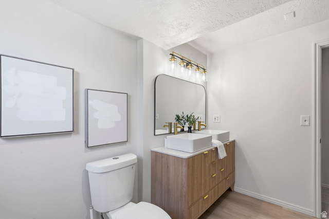 2460 Allison Way Syracuse, UT 84075 - Photo 11 of 24 Dual rectangular vessel sinks with gold-finish faucets and a wood-finish vanity with gold hardware