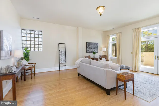 a bedroom with a bed dresser and wooden floor