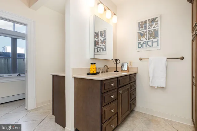 a bed sitting in a bedroom next to a window with a rug