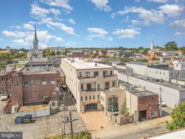an aerial view of residential building and trees around