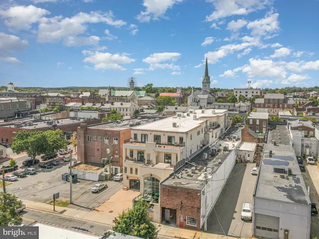 an aerial view of residential houses with outdoor space