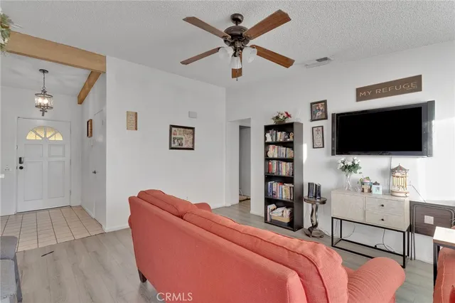 a bedroom with furniture and a flat screen tv